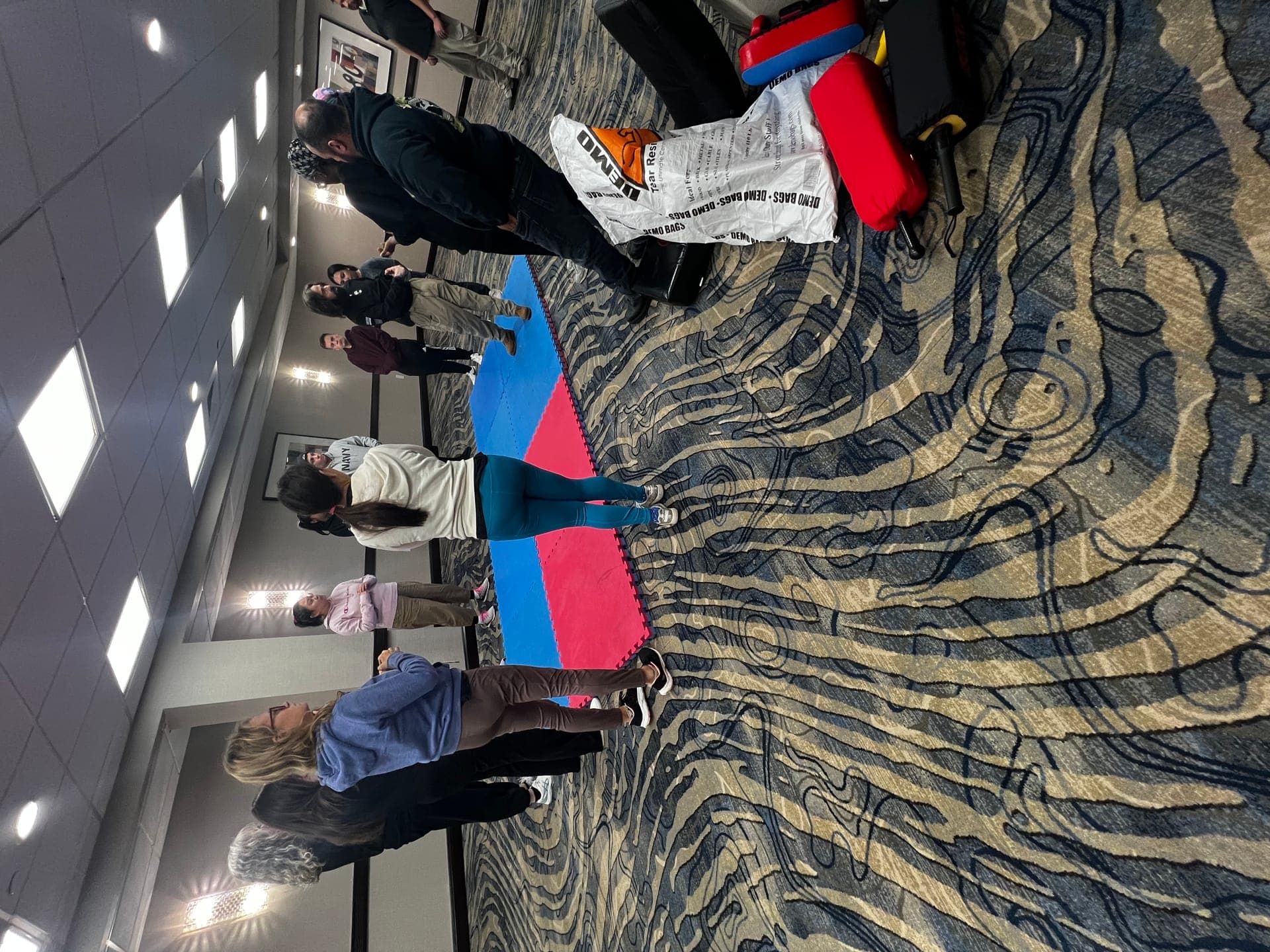Self-defense training class — group exercise on training mats