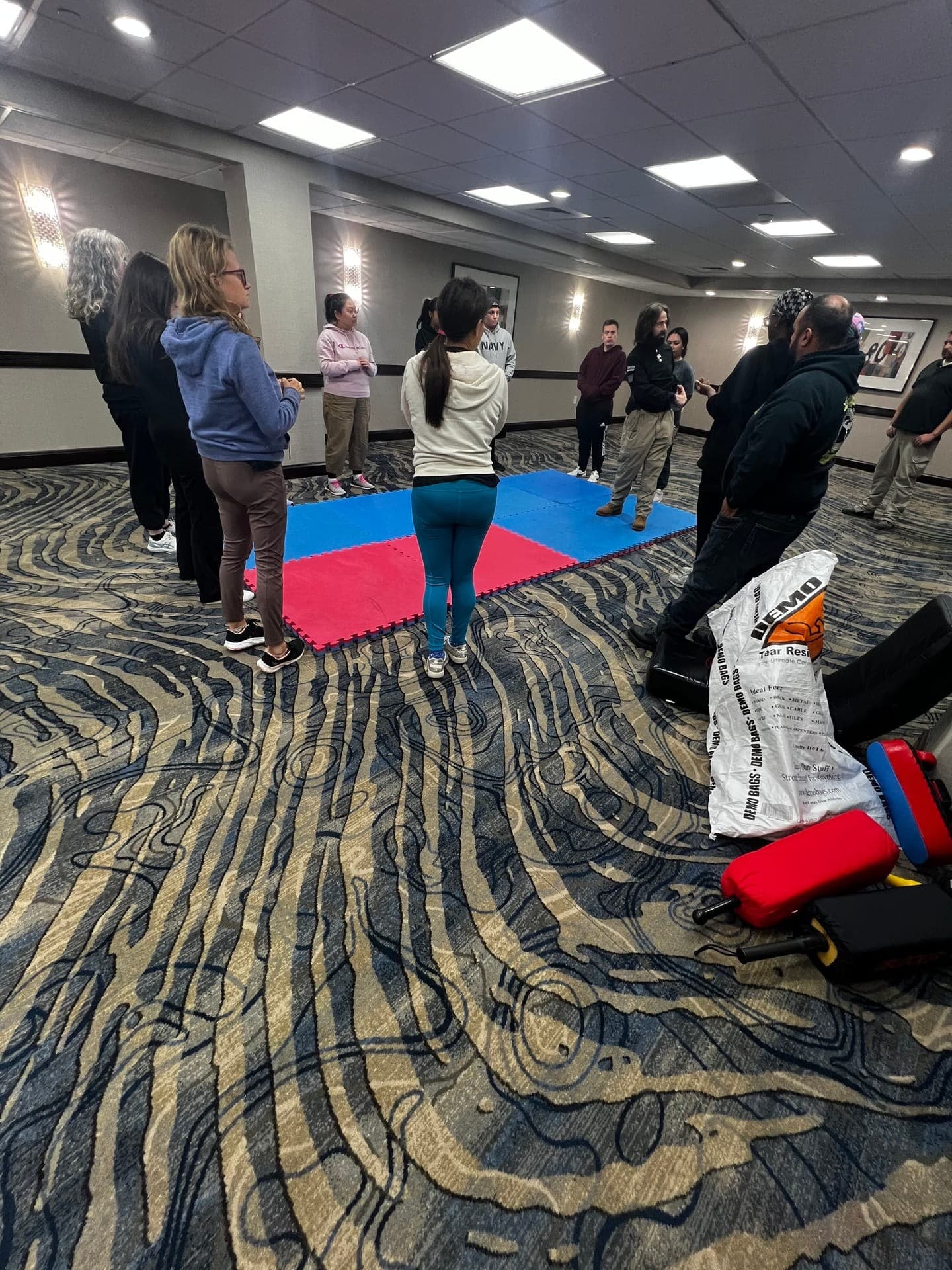 Self-defense training class — group exercise on training mats
