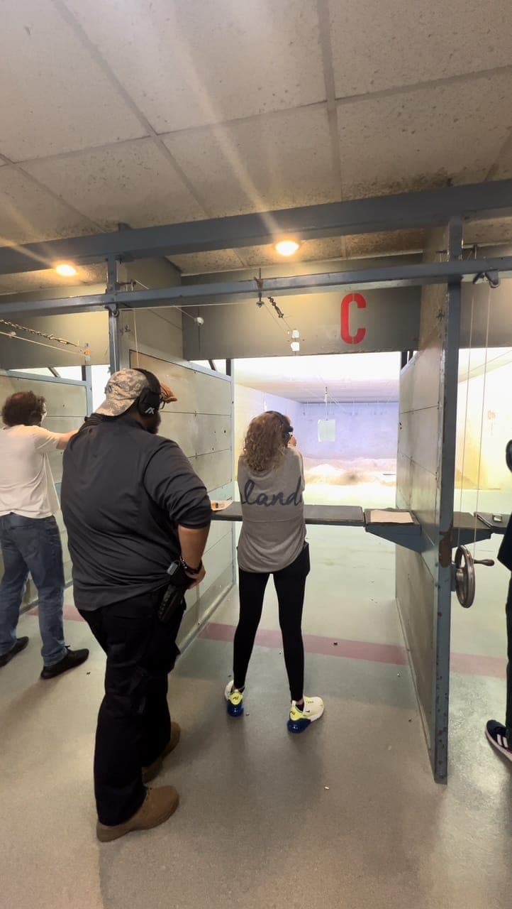 Instructor supervising student at firing range lane C